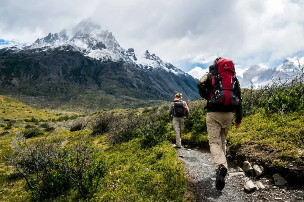 Mochilero en ruta de montaña con seguro de viaje de aventura contratado